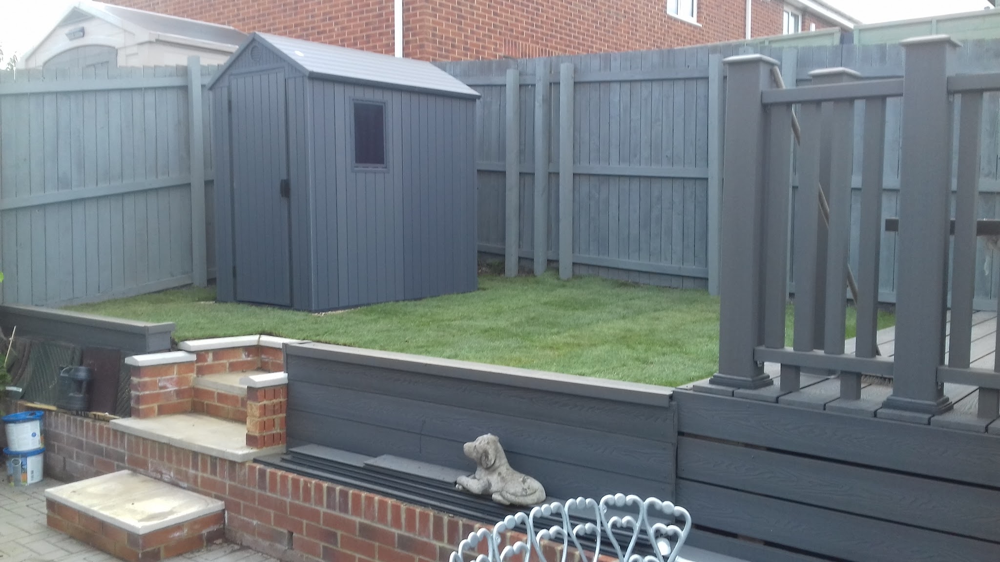Grey-painted fencing, decking steps, a new shed and fresh lawn